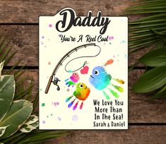 a fathers day card with two handprinted hands and a fishing rod on it