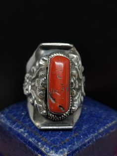 This stunning vintage ring has incredible unique style, the ring originates from Tibet where tribal jewellery is a highly skilled roll. This item would have been crafted for the tourist market in the early to mid 20th century and features large natural coral gemstone set in sterling silver saddle ring.  UK size - W1/2 US size - 11.25 length approx - 30mm Message me any questions  ITEM - S1390 Unique Oval Jewelry For Ceremonial Occasions, Vintage Ceremonial Rings With Gemstones, Vintage Ceremonial Gemstone Ring, Vintage Ceremonial Ring With Gemstone, Antique Carved Collectible Ring, Vintage Carved Jewelry For Ceremonial Occasion, Antique Untreated Silver Rings, Artisan Carved Adjustable Ring, Vintage Carved Filigree Ring Gift