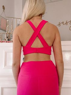 The Emma Sports Bra Top from Sassy Shortcake is hot pink and features overlay straps on back with a hook closure. This top has four way stretch, removable pads, and moisture wicking fabric. Model wearing size small. Matching leggings also available. Nylon Strappy Back Activewear For Workout, Nylon Activewear With Strappy Back For Workout, Cross Back Stretch Activewear For Sports, Nylon Stretch Cross-back Activewear, Stretch Cross-back Activewear For Training, Stretch Cross Back Activewear For Training, Stretch Nylon Activewear With Cross Back, Functional Stretch Activewear With Cross Back, Stretch Cross Back Sportswear Activewear