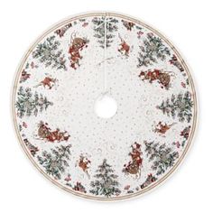 a white and red christmas tree skirt with reindeers on the bottom, surrounded by holly