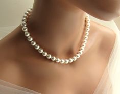 This trendy large pearl necklace is handmade in your choice of vegan white or ivory/cream 10mm pearls. The necklace includes a 3 inch silver figaro chain extension, embellished with a pearl drop, for adjustable sizing. ♥ All jewelry comes in a gift box and is ready to give! ♥ Want to see similar items? There are many more unique items at my shop, including children's jewelry! Back to main shop: http://etsy.me/29ztspj Real Pearl Necklace Vintage, Pearls Backdrop, Ball Jewellery, Big Pearl Necklace, Large Pearl Necklace, Charm Bracelets For Girls, Silver Figaro Chain, Chunky Pearl Necklace, Backdrop Necklace