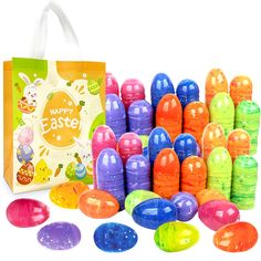 an assortment of colorful plastic easter eggs in front of a bag with happy easter written on it