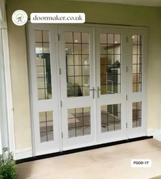 a white double door with glass panels and sidelights