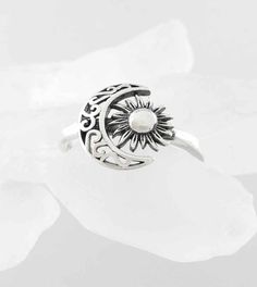 Material: 100% Sterling silver Weight: 2.1 grams Crescent and flower together are 1/2 inch wide x more than 3/8 inch tall (12 x 11mm) Band is more than 1/16 inch wide (2mm) Item number: wh295 The vine-like scrollwork of the crescent moon and the petal-like rays of the sun give this celestial ring an earthy character. The sun is also oxidized for an aged effect and the crescent is cut-out to make the scrollwork more lacey. Symbolic Silver Jewelry With Sun And Moon Design, Silver Sun And Moon Design Jewelry For Anniversary, Bohemian Silver Moon Charm Ring, Spiritual Silver Crescent Rings, Silver Jewelry With Sun And Moon Design For Anniversary, Bohemian Silver Ring With Moon Charm, Adjustable Crescent Silver Jewelry, Silver Jewelry With Sun And Moon Design, Bohemian Silver Jewelry With Sun And Moon Design