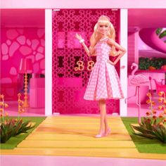 a barbie doll standing in front of a pink room