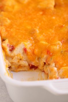 a casserole dish filled with chicken and cheese