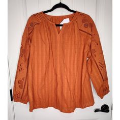 This Is A Women's Blouse Sold By Cracker Barrel In Rust Brown Color And Size M. It Has A V-Neckline, Long Sleeves, And A Pullover Closure. The Blouse Is Made Of A Cotton Blend Fabric With Embroidered Lace Accents. It Is A Regular Fit And Style, Suitable For Casual And Business Occasions During Fall, Winter, And Spring Seasons. New With Tags. Casual Embroidered V-neck Top For Fall, Embroidered Orange V-neck Tops, Orange Embroidered V-neck Top, Casual Long Sleeve Embroidered Top For Brunch, Orange V-neck Blouse For Brunch, Casual Orange Embroidered Blouse, Casual V-neck Embroidered Top For Fall, Spring Embroidered Orange Blouse, Cotton Blend Fabric