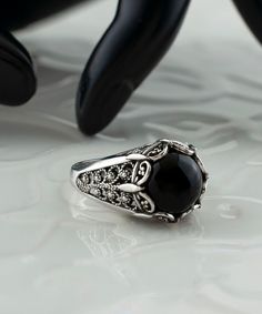 Black Onyx Silver Gothic Cocktail Ring, 925 Sterling Silver Artisan Handmade Medieval Goth Filigree Statement Ring Black stone ring, crown ring, punk ring for women, vintage jewelry Material: 925 Sterling Silver ( NICKEL FREE ) Gemstone: Black Onyx 10 mm. FREE, FAST AND TRACKABLE SHIPPING FOR ALL EU COUNTRIES AND USA. COMES WİTH VELVET POUCH AND LUXURY GİFT BOX. Show off this gorgeous black stone ring at any occasion. This eye catching ring is perfect to add glam to any outfit with Onyx Gemstone. This vintage, original, and stylish luxury jewelry is perfect for wearing at parties, festivals and everyday life.  Our handmade pieces are the perfect gift ring for her, mom, wife, daughter, friend, lover, relative, etc. ideal gift for birthday, anniversary, christmas, graduation, and mothers day Gothic Black Skull Ring, Victorian Style Black Sterling Silver Rings, Victorian Black Sterling Silver Rings, Gothic Engraved Ring Jewelry, Black Ring With Intricate Design, Ornate Black Sterling Silver Rings, Gothic Black Skull Ring For Anniversary, Black Skull Promise Ring, Gothic Black Formal Ring