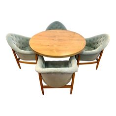 three chairs and a table with a round wooden table on one side, in the middle