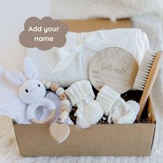 a box filled with baby items on top of a bed