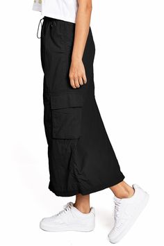 Chic, parachute skirt with an elastic waistband, a drawstring cinch tie and cargo pockets down the sides. Pair it with a graphic tee and sneakers for an effortless streetwear look. CARE | Machine Wash Cold CONTENTS | 100% Nylon MEASUREMENTS | 33"/85 cm Top to Bottom (Size Small) MODEL | 5'8 - wearing a size Small IMPORTED Parachute Skirt, Cargo Skirt, Graphic Tee, Graphic Tees, Street Wear, Elastic, Skirt, Sneakers, How To Wear