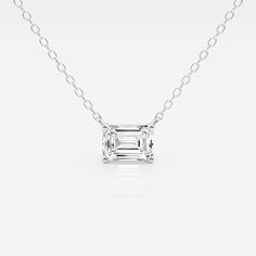 an emerald cut diamond necklace on a white background