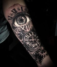 a man's arm with an eye and clock on it