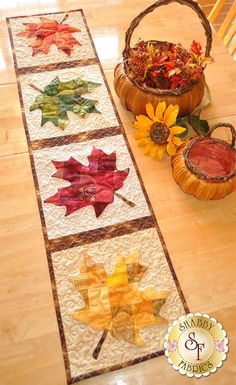 the table runner is decorated with autumn leaves