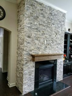 a living room with a fireplace and bookcases