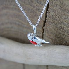 A firm British favourite, our perfect sterling silver Robin necklace is bursting with personality, with his beautiful red enamel breast and will bring a cheer to the dullest winter days. Perfect for a present to yourself or a friend and will add colour to your Festive Outfits. Matching drop earrings also available to complete your look. Sterling silver Coloured enamel detail High shine finish Robin measures 13mm across Made From recycled sterling silver Adjustable 16-18" sterling silver chain Un Robin Necklace, Robin Red Breast, Festive Outfits, Outfits Matching, Bird Necklace, Bee Necklace, Bird Jewelry, Stylish Gifts, Recycled Sterling Silver