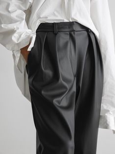 Loose fit vegan leather trousers with low waist, double pleated waistband and belt loops. Made from high quality PU. Fabric contains natural stretch. Model is in MINUSEY S. ✔️ Free worldwide express shipping over $100✔️ Loved by 6,500+ customers✔️ Limited edition collections, maximum style⠀⠀⠀⠀⠀⠀⠀⠀⠀Stay ahead of the trend with can’t-find-anywhere-else staples. Your closet will thank you 💕* MINUSEY S = EU 34, US 2* MINUSEY M = EU 36, US 4* 100% PU Leather* Hand wash cold or professional clean* Made in Korea - Model Height: 169cm/5'6" (US2, EU34) Business Casual High-waisted Leather Pants With Belt Loops, High-waisted Leather Pants For Business Casual With Belt Loops, Business Casual High-waisted Leather Pants, Sleek Leather Pants With Belt Loops For Work, Sleek High-waisted Leather Pants With Belt Loops, Elegant Leather Bottoms With Belt Loops, High Waist Leather Pants For Workwear With Belt Loops, High Waist Leather Pants With Belt Loops For Work, Sleek Ankle-length Pants With Belt Loops