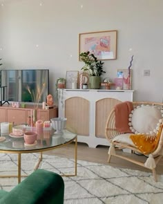 a living room filled with furniture and a flat screen tv sitting on top of a wooden table