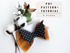 the bow tie is next to cotton flowers