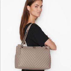 Victoria’s Secret The Shoulder V-Quilt Tote Bag Condition: New In Package Size: 4" L X 5.9" D X 10.2" H Strap Drop: 9.4” Color: Taupe Polished And Classic, Always Ready To Work. This Bag Combines Both Fashion And Function In One Wear-Everywhere Style That’s Perfect To Tote Your Laptop. In Our Signature V-Quilt Finish With V Monogram Hardware. Fits: Phone, Wallet, Keys, A Small Laptop And Everyday Essentials Open Top With Snap Closure 1 Interior Zipper Pocket Imported Polyurethane Elegant Taupe Shoulder Bag With Silver-tone Hardware, Chic Victoria's Secret Shoulder Bag For Errands, Elegant Victoria's Secret Tote Shoulder Bag, Everyday Elegant Victoria's Secret Shoulder Bag, Elegant Everyday Victoria's Secret Shoulder Bag, Elegant Victoria's Secret Shoulder Bag For Everyday, V Monogram, Victoria Secret Backpack, Cinch Bag