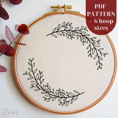 an embroidery hoop with leaves on it