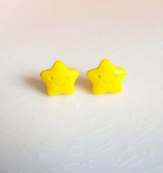 Star Stud Earrings Cute bright yellow star earrings with a happy little face engraved, perfect gift to brighten someones day or a treat to brighten your own. Attached to stainless steel push back earrings with industrial strength glue. Glazed for shine and protection. Lightweight and comfy to wear. Comes on a handmade card with decorative washi tape, wrapped in tissue paper, if a handwritten note is required please mark in notes. I sell an array of kawaii, pastel, fantasy and videogame inspired Handmade Star-shaped Earrings For Gift, Fun Star-shaped Jewelry For Gifts, Fun Yellow Jewelry For Birthday, Playful Star Charm Jewelry For Gifts, Playful Jewelry With Star Charm For Gift, Playful Adjustable Yellow Earrings, Cute Smiley Face Earrings For Gift, Cheerful Smiley Face Jewelry As Gift, Handmade Yellow Star-shaped Jewelry