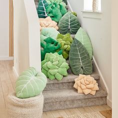 there are many stuffed animals on the stairs in this house, and one is green