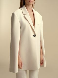 Founded in 2016 by sisters Marina and Francesca Moscone, the label gravitates toward a tactile approach, twisting and draping fabrics by hand to create a softly seductive design using custom jacquards, fil-coupés, and silk wools, all exclusively developed in Italy, rendered in precise shapes and tailoring. A subtle tension between the masculine and feminine underpins each collection. The classics are reimagined with the coveted Boyfriend Blazer and its exaggerated proportions. Product Details 72 Draping Fabric, Boyfriend Blazer, Cape Sleeves, Silk Wool, Color Ivory, The Label, Cool Designs, Coats Jackets, In Italy