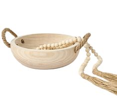 a wooden bowl with beads and tassels