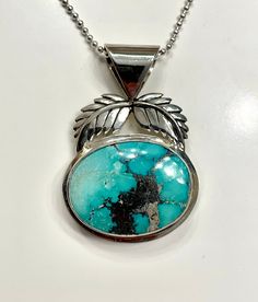 "This Custom, hand made Gem High-Grade Old Stock Kingman Turquoise Sterling Silver Pendant weighs 9.15 grams. The cabochon weight is 15.6 Ct. and is unbacked. The pendant Measures approximately 1 5/8\" long including bale and 1 1/16\" wide. The stone measures approximately 23.3 mm, by 18 mm, by 4.4 mm The black Matrix is actually Pyrite mixed with quartz. Following numerous requests from those of you that do not have a jeweler. I will now offer for sale custom one of a kind silversmith jewelry f Elegant Handmade Turquoise Chrysocolla Necklace, Unique Polished Turquoise Necklace, Unique Turquoise Jewelry With Polished Finish, Turquoise Cabochon Chrysocolla Necklace, Unique Turquoise Cabochon Necklace, Turquoise Jewelry With Large Oval Pendant, Turquoise Gemstone Oval Pendant Jewelry, Unique Turquoise Cabochon Pendant Necklace, Southwestern Oval Necklace With Natural Stones