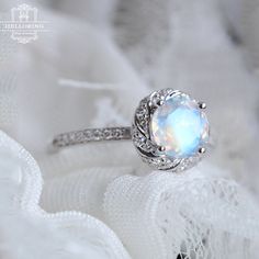 a ring with an opal center surrounded by white lace