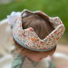 Perfect for dress up, pretend play, or a birthday celebration this sweet floral crown is made of 100% cotton. It features a floral print with pink, blue and peach on a light background. The crown fits most kids 1+. Capture those birthday party memories or foster imaginative play all while looking adorable.  The crown body measures 16x4 inches, with adjustable white ties. The crown is soft and puffy, but stands up well.  Care - machine wash in cool water and dry on low heat or hang dry. Iron if n White Ties, Fabric Crown, Crown Pink, 2024 Halloween, Toddler Play, First Birthday Gifts, Birthday Crown, Easter Girl, Princess Crown