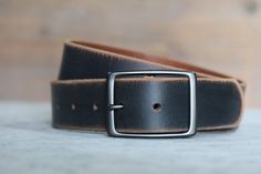 "We take pride in making belts. We use the highest quality leather to deliver an outstanding product that will last decades. All of our Leather Belts are cut from FULL GRAIN, 9 oz., Veg tanned Double shoulders. Our Vintage belts are distressed and antiqued to give each piece a unique finish. These belts have a snap enclosure, so changing out buckles is simple and quick. We also make our leather belts with 7 holes for optimum sizing for a sure fit. Belts are 1.5\" wide. Sizing is easy. Simply ref Rugged Vintage Brown Leather Belts, Black Leather Belts With Rivets, Vintage Brown Rugged Leather Belt, Black Leather Belt With Rivets, Vintage Brown Belts With Rivets, Black Leather Belt, Vintage Belts, Garden City, Leather Belts