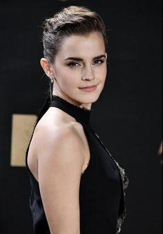 an image of a woman in black dress posing for the camera with her hand on her hip