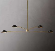 a brass chandelier with five black shades hanging from it's center point