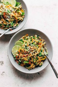 two bowls filled with food on top of a table