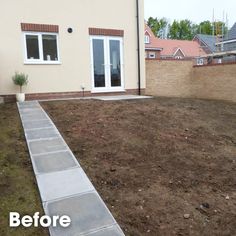 an empty backyard with grass and dirt in the foreground, before and after landscaping