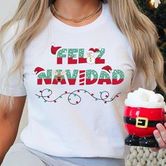 This Feliz Navidad shirt is perfect for spanish Christmas. This classic Bella Canvas unisex jersey short sleeve tee fits like a well-loved favorite. Soft cotton and quality print make users fall in love with it over and over again. These t-shirts have-ribbed knit collars to bolster shaping. The shoulders have taping for better fit over time. Dual side seams hold the garment's shape for longer.  .: 100% Airlume combed and ringspun cotton (fiber content may vary for different colors) .: Light fabric (4.2 oz/yd² (142 g/m .: Retail fit .: Tear away label .: Runs true to size Items shown in mock photo are not included- just the shirt.    To view other unique designs, visit my full shop at: https://etsy.me/3Qg9Xbn. DIRECT TO GARMENT (DTG) PRINTING: Direct to Garment printing is when a high resol Feliz Navidad Shirt, Spanish Christmas, Matching Family Christmas Pajamas, Family Christmas Pajamas, Merry Christmas Shirts, Pajama Shirt, Christmas Pajamas, Family Christmas, Christmas Shirts