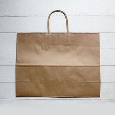 a brown paper bag sitting on top of a white wall