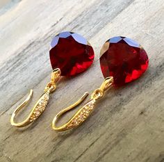 "Burgundy Garnet gold pave earrings. Heart cut garnets. Red stone jewelry. Red garnet dangles. Dark red garnet drops. Junuary birthstone. Available in 3 finishes. Length 1 1/4\". Dark red faceted gems are 14x14 mm as photo are sold, 19x14 mm and 13x17 mm stones are available. These beautiful earrings will arrive in a jewelry box ready for gift giving." Ruby Earrings For Valentine's Day, Ruby Gemstone Earrings As Gift, Lab-created Ruby Gemstone Earrings As Gift, Lab-created Ruby Gemstone Earrings For Gift, Red Ruby Birthstone Earrings, Ruby Jewelry With Earrings For Valentine's Day, Valentine's Day Ruby Jewelry With Matching Earrings, Red Gemstone Earrings For Valentine's Day, Red Garnet Earrings Gift