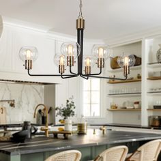 a chandelier hanging from the ceiling in a kitchen