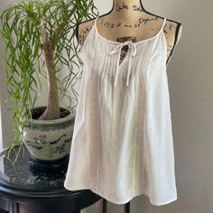 This Cute Loft Trapeze-Style Camisole Features Tone On Tone Embroidery, Gathered Neckline, Pin Tucking Bodice, Keyhole Tie Front Closure And Front Lace Details. Made From A Sheer Cotton/Rayon Blend Giving It A Beautiful Ethereal Appearance. Color: Baby Pink * Length Approx 27” From Shoulder Feminine Cotton Camisole For Vacation, Feminine Cotton Camisole For Beach, Summer Camisole With Floral Embroidery And Spaghetti Straps, Cotton Camisole With Floral Embroidery, Floral Embroidered Camisole With Spaghetti Straps For Summer, Casual Floral Embroidered Spaghetti Strap Top, Cotton Floral Embroidered Camisole, Casual Floral Embroidery Spaghetti Strap Top, Casual Tops With Floral Embroidery And Spaghetti Straps