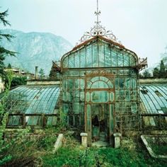 an old greenhouse with lots of glass in it