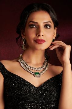 Presenting a captivating two-layer Polki set featuring a stunning emerald Polki stone at its center, accompanied by matching earrings. This ensemble exudes drama and elegance, perfect for adding a touch of regal charm to any occasion. Finish: Rhodium Material: Brass, Polkis & Emerald Stones Color: White, Green Size: Free Size, Adjustable Closure Type: Draw String Box Contains: 1 Necklace, 1 Pair of Earrings Glamorous Green Sets For Reception, Elegant Kundan Emerald Necklace For Festive Occasions, Elegant Emerald Kundan Necklace For Festive Occasions, Elegant Silver Kundan Necklace With Emerald, Elegant Green Kundan Necklace, Elegant Green Kundan Necklace For Festive Occasions, Elegant Hand Set Emerald Necklace For Reception, Elegant Hand-set Emerald Necklace For Reception, Elegant Emerald Bridal Necklace For Festive Occasions