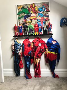 the wall is decorated with superheros and batman figurines