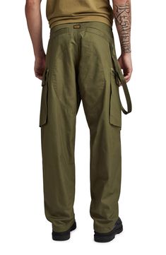 These loose-fitting, military-inspired twill pants feature roomy cargo pockets and woven tape inside the hems that can be adjusted to slightly taper the legs. Zip fly with button and drawstring closure Front slant pockets; side flap-patch zip pockets; back welt pockets 100% cotton Machine wash, line dry Imported Combat Style Cotton Parachute Pants With Straight Leg, Combat Style Cotton Parachute Pants, Cotton Combat Parachute Pants With Straight Leg, Military Style Cotton Parachute Pants With Multiple Pockets, Combat Style Cotton Cargo Jeans With Belt Loops, Cotton Combat Cargo Jeans With Belt Loops, Military Style Baggy Pants With Patch Pockets, Utility Parachute Pants With Belt Loops, Combat Style Cotton Parachute Pants With Belt Loops