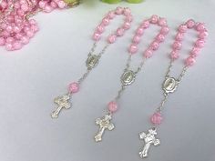 45 beautiful small rosaries for baptism favors they are pearlized pink color beads in the shape of a cute rose bud, accented in gold or silver tone . beads are 6mm imported, acrylic in the shape of a rose bud all hand made with image of our lady of guadalupe in center piece. measure 4.5' inches long. small cross has a cute litle heart in the midle. hablamos espanol, si tiene preguntas con gusto le ayudamos Silver Baptism Jewelry With 8mm Beads, Silver Beaded Rosary For First Communion, Silver Jewelry With 8mm Beads For Baptism, Personalized Silver Rosary For Confirmation, Silver Rosary Bracelet With Round Beads For Baptism, Silver Rosary Bracelet With 8mm Beads As Gift, Silver Rosary Bracelet With Round Beads For First Communion, Personalized Silver Rosary For First Communion, Silver Spiritual Rosary Bracelet For First Communion