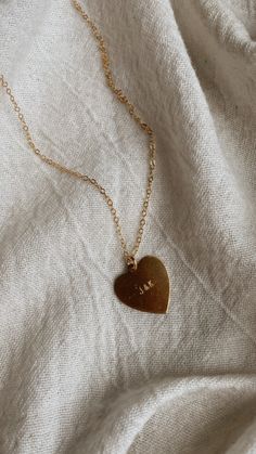 A beautiful brass heart pendant for on a 14k gold filled chain. Completely personalizable for you! Can also be left blank.  Comes in a box perfect for gifting. first picture shown is Minnie font, others are Margaux. Gold Heart Necklace, Gold Filled Chain, In A Box, Heart Necklace, A Box, One Pic, Heart Pendant, Pendant Necklaces, Gold Filled