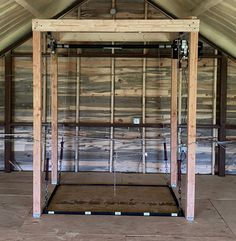 the inside of an unfinished building with wood framing and electrical wires hanging from the ceiling