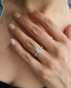 a woman's hand with a diamond ring on it